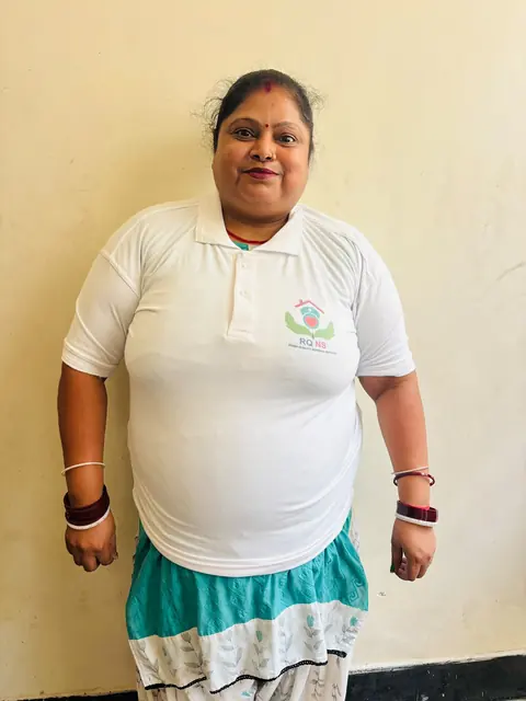 Female team member in a white uniform polo